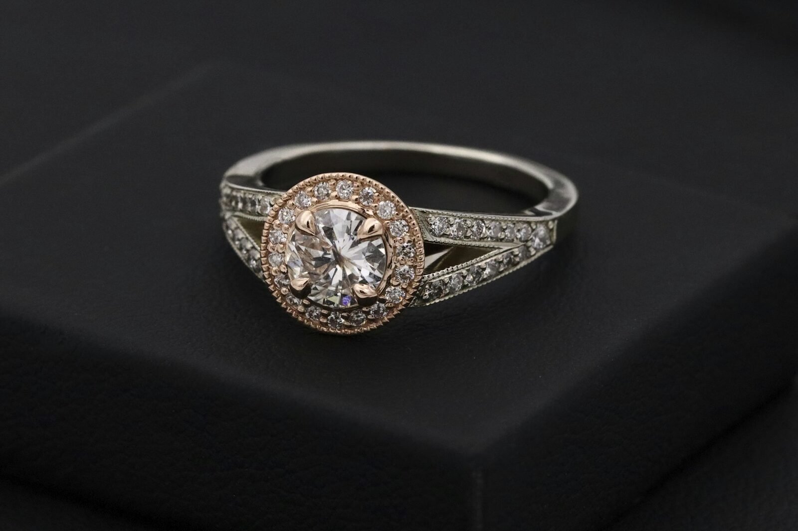 A solitaire diamond ring on a presentation box