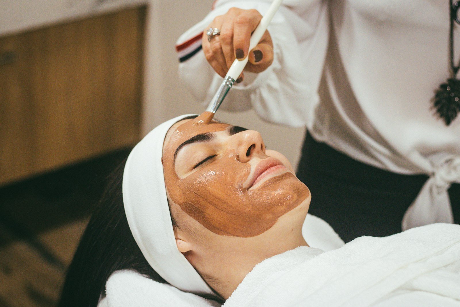A face mask being applied during a spa facial